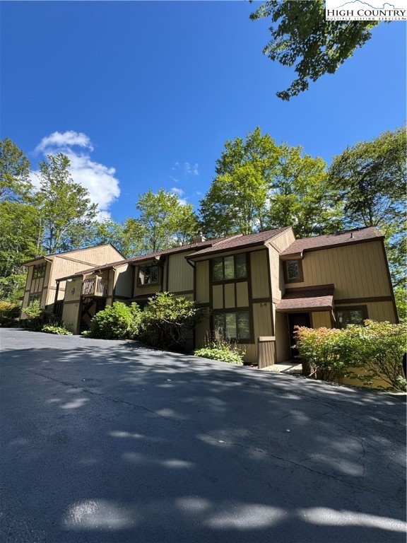 175 Ridgeview Road, Unit 2 Sugar Mountain, NC 28604 - Photo 1 of 20 a front view of a house with a yard and a garage