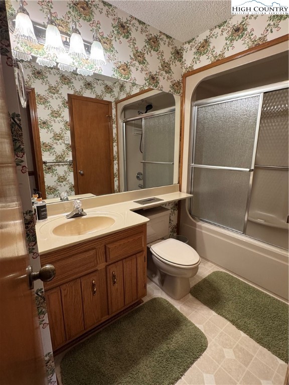 175 Ridgeview Road, Unit 2 Sugar Mountain, NC 28604 - Photo 12 of 20 a bathroom with a granite countertop toilet sink and mirror