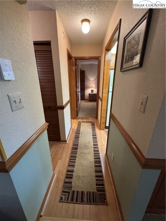 175 Ridgeview Road, Unit 2 Sugar Mountain, NC 28604 - Photo 10 of 20 a view of a hallway with wooden floor and staircase