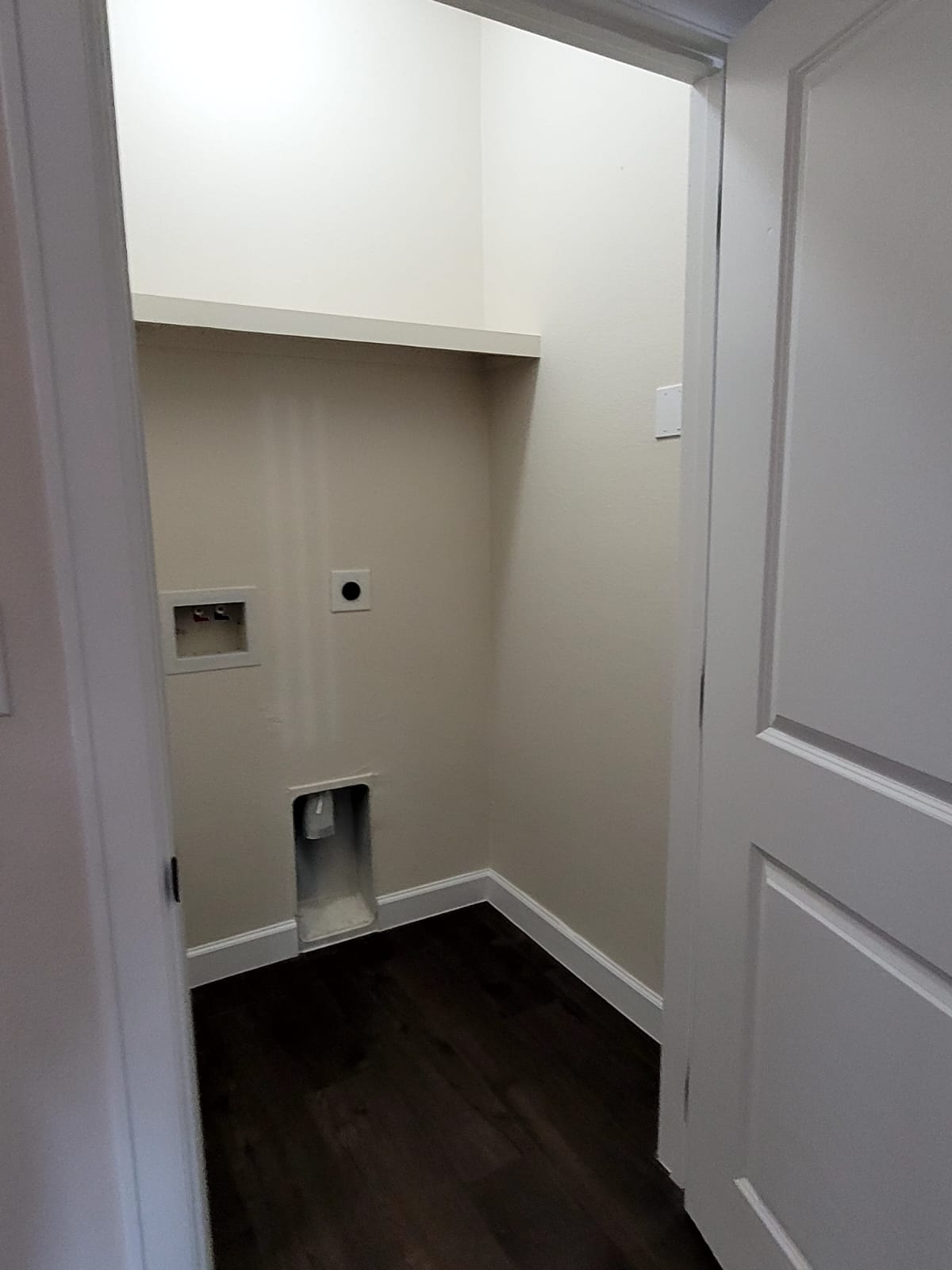 750 South Main Street Lockhart, TX 78644 - Photo 10 of 31 Laundry area featuring dark wood-style floors, washer hookup, and electric dryer hookup