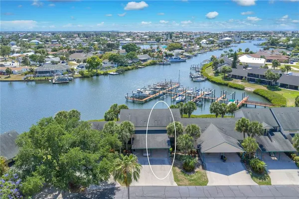 an aerial view of a houses with a lake