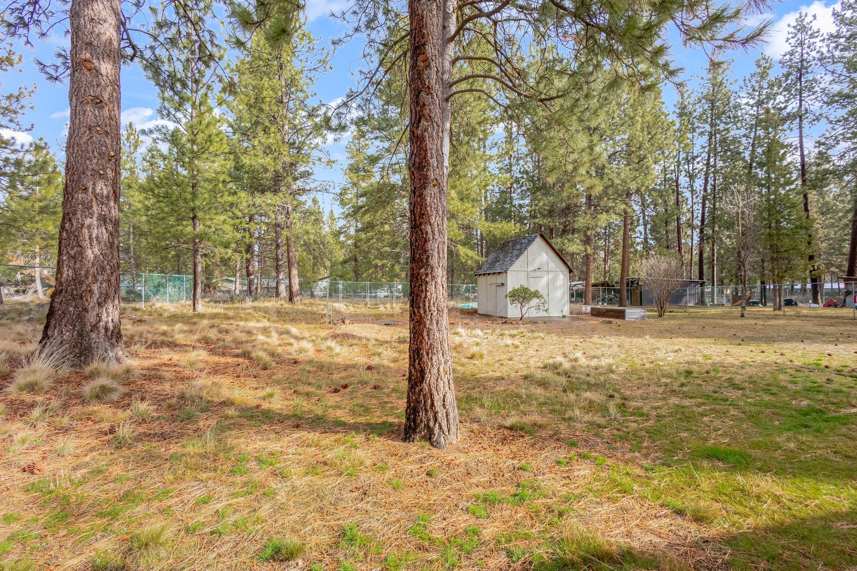 18900 Tuscarora Lane Bend, OR 97702 - Photo 16 of 20 a view of a wooden house with a yard