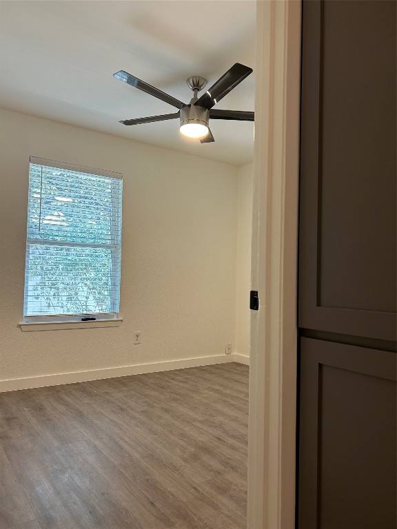 5903 Cougar Drive, Unit B Austin, TX 78745 - Photo 5 of 16 an empty room with wooden floor closet and windows