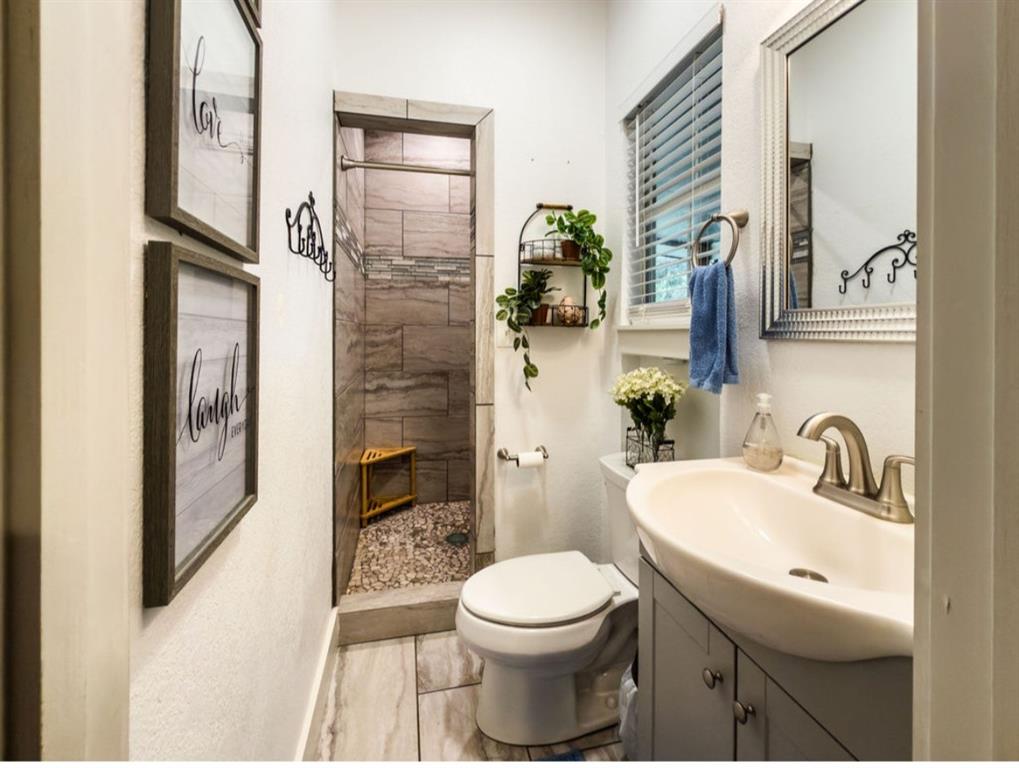 14275 Gholson Road Gholson, TX 76705 - Photo 16 of 22 Contemporary bathroom featuring a walk-in shower with stone tile surround and pebble flooring