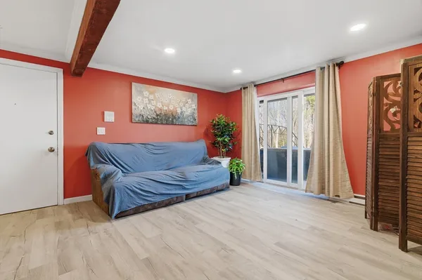 a spacious bedroom with a bed and a couch