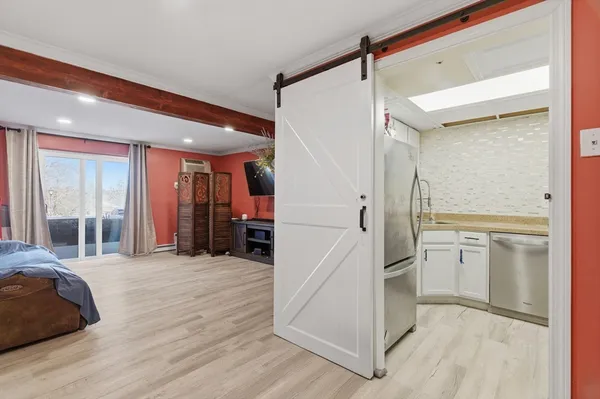 a kitchen with white cabinets and sink