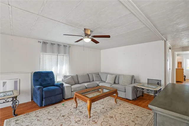 a living room with furniture a rug and a window