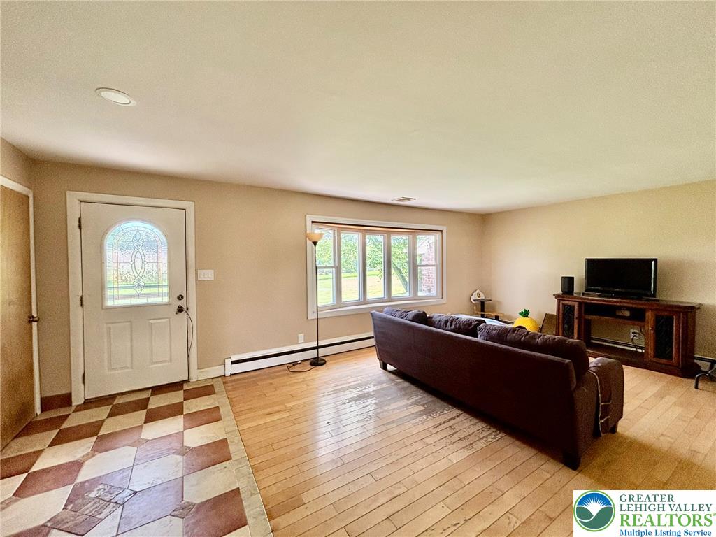 8813 Bluejay Road Kempton, PA 19529 - Photo 8 of 23 This living room features ample natural light and a blend of classic flooring.