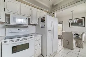 a kitchen with stainless steel appliances a stove microwave and refrigerator