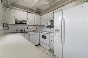 a kitchen with stainless steel appliances a refrigerator sink and cabinets
