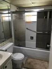 a bathroom with a toilet and a shower