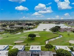 an aerial view of a houses with a lake view