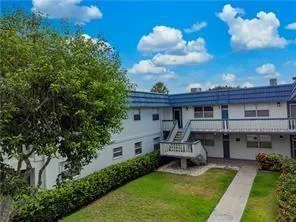 a view of a patio with table and chairs and potted plants