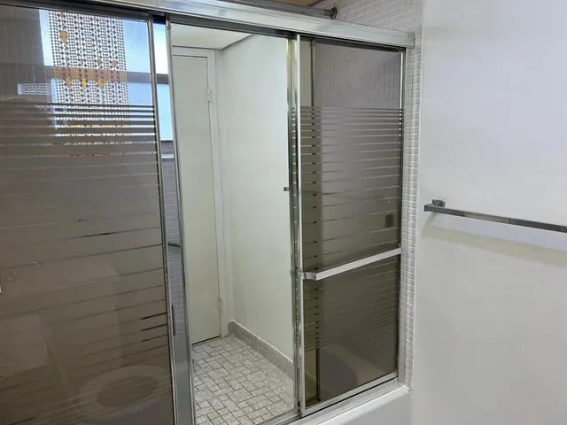 a bathroom with a glass shower door