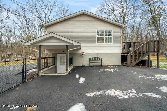 a view of a house with wooden fence