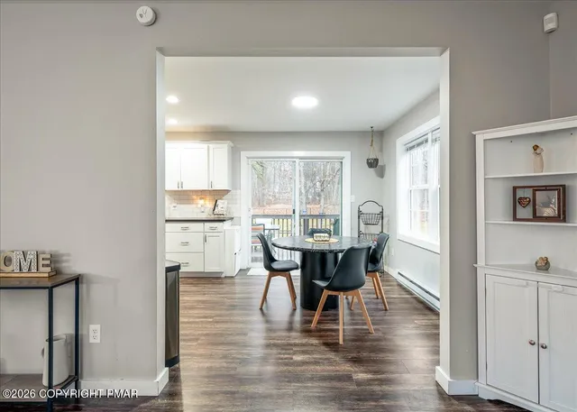 a view of a dining room with furniture and wooden floor