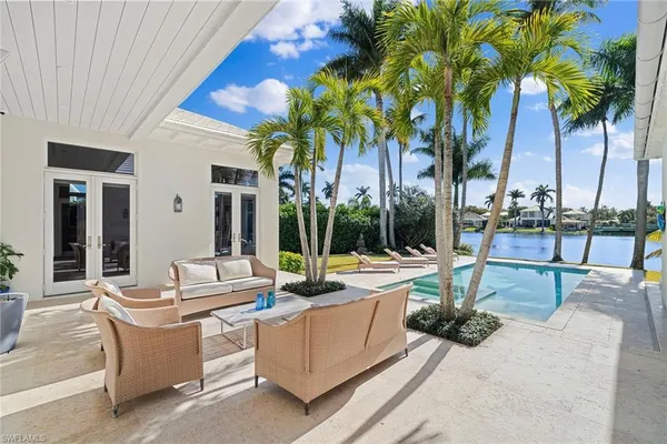 a view of a house with swimming pool and sitting area