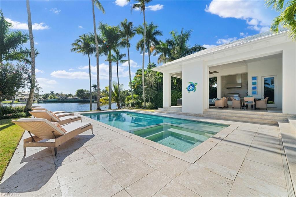 575 Palm Circle East Naples, FL 34102 - Photo 20 of 49 a view of a patio with a dining table and chairs with a patio