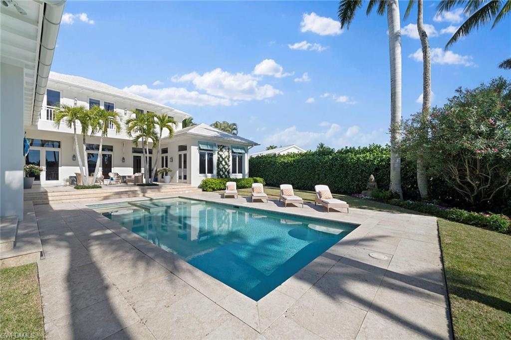 575 Palm Circle East Naples, FL 34102 - Photo 22 of 49 a view of a swimming pool with a patio