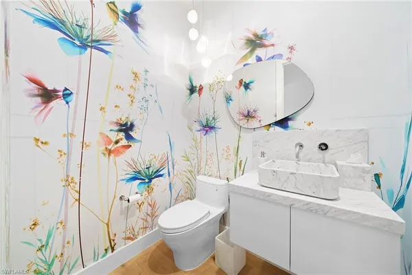 a bathroom with a sink a toilet and a mirror