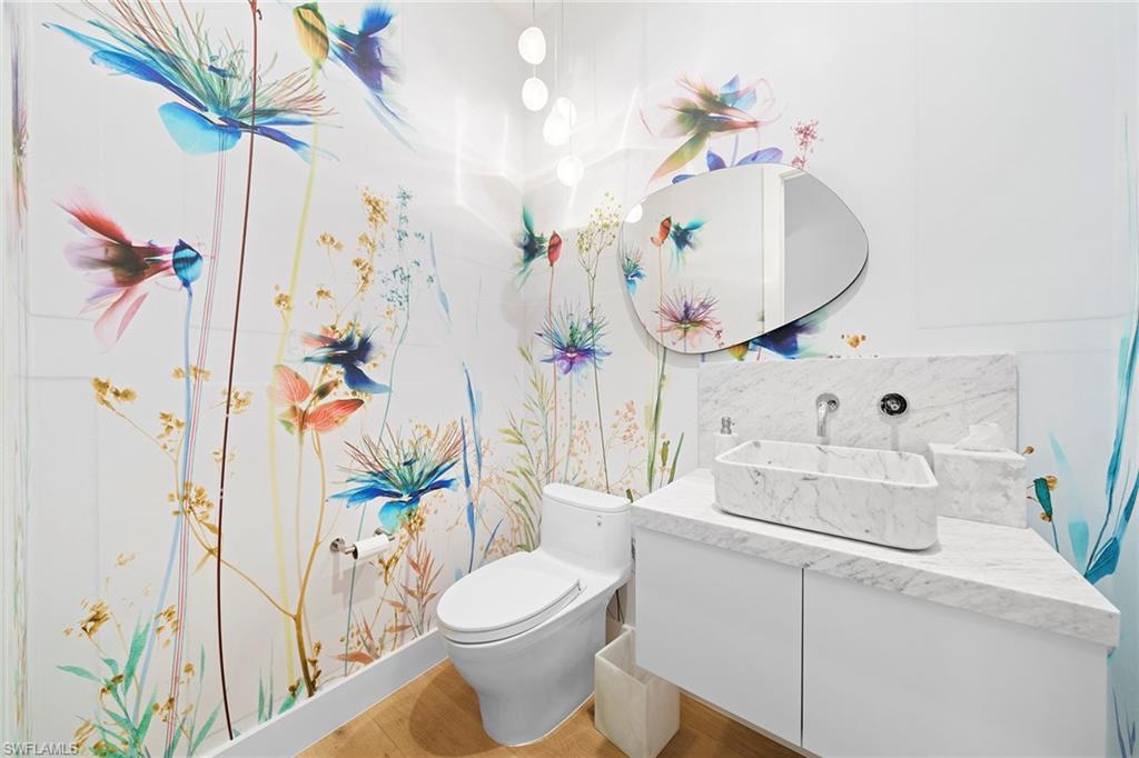 575 Palm Circle East Naples, FL 34102 - Photo 31 of 49 a bathroom with a sink a toilet and a mirror