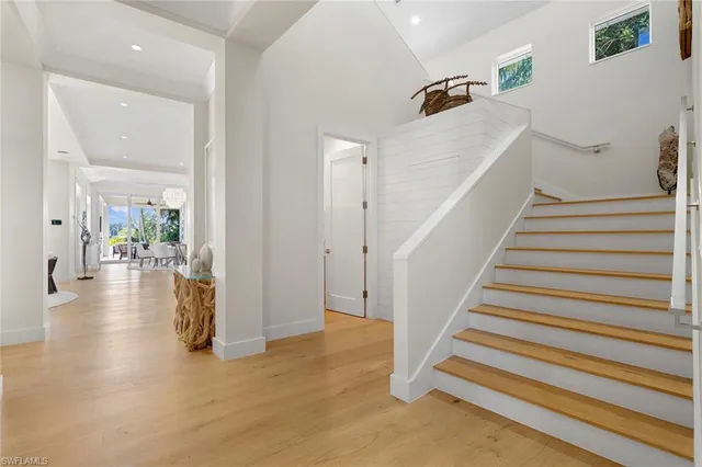 a view of entryway and hall with wooden floor