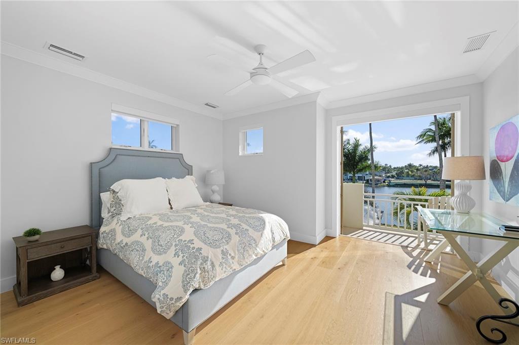 575 Palm Circle East Naples, FL 34102 - Photo 39 of 49 a bedroom with a bed and a table