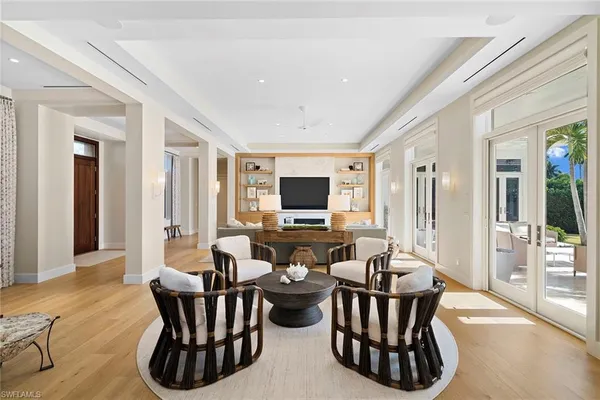 a living room with furniture wooden floor and a flat screen tv