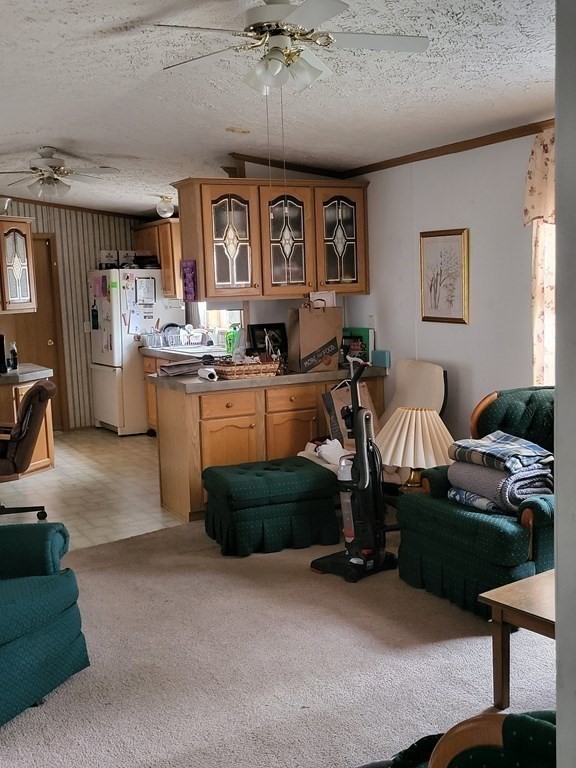365 Main Street, Unit 2 Sturbridge, MA 01566 - Photo 11 of 24 a living room with furniture and a chandelier