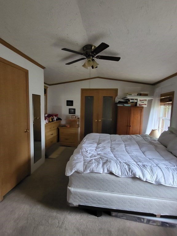 365 Main Street, Unit 2 Sturbridge, MA 01566 - Photo 17 of 24 a bedroom with a bed and a mirror