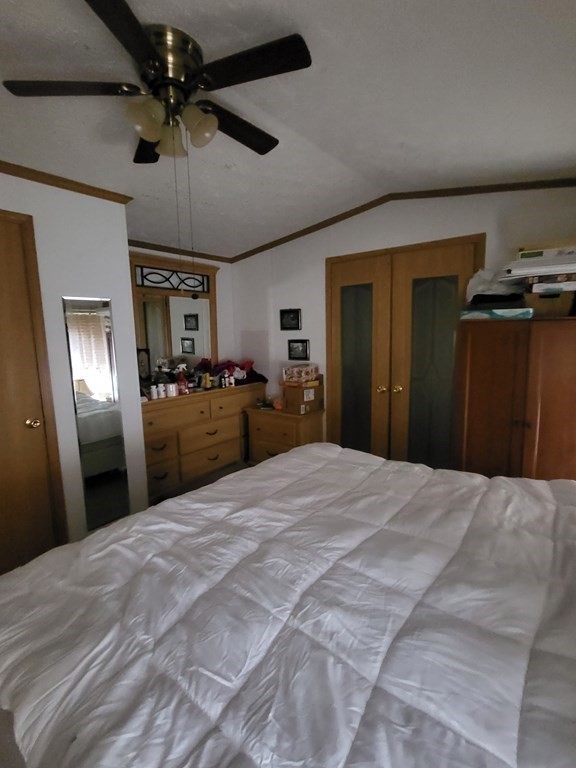 365 Main Street, Unit 2 Sturbridge, MA 01566 - Photo 18 of 24 a large bedroom with a bed and a chandelier