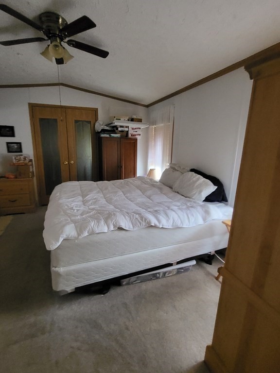 365 Main Street, Unit 2 Sturbridge, MA 01566 - Photo 19 of 24 a bedroom with a bed and a mirror