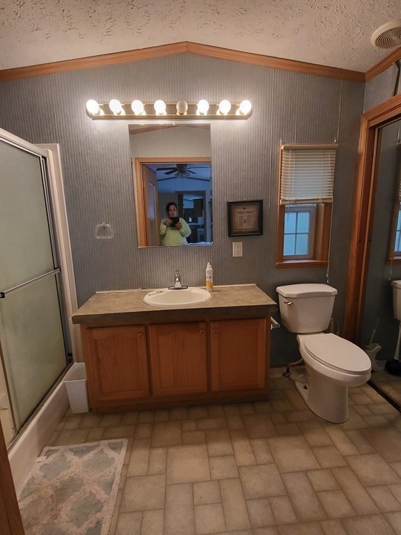 365 Main Street, Unit 2 Sturbridge, MA 01566 - Photo 20 of 24 a bathroom with a sink a toilet and mirror