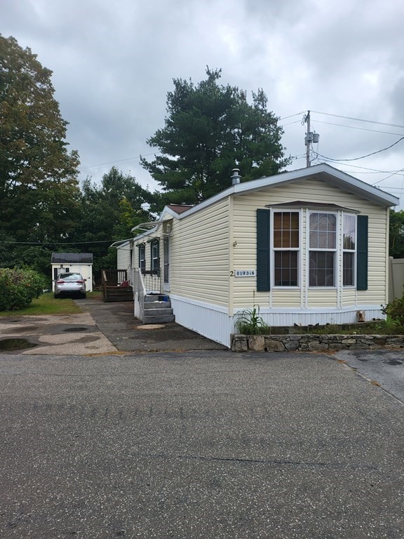 365 Main Street, Unit 2 Sturbridge, MA 01566 - Photo 5 of 24 a front view of a house with a yard and garage
