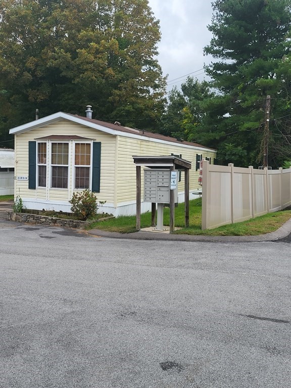 365 Main Street, Unit 2 Sturbridge, MA 01566 - Photo 7 of 24 a front view of a house with a yard and potted plants