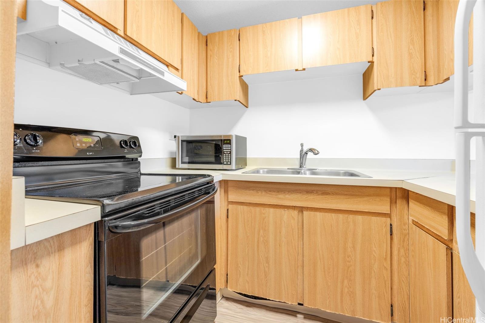 a kitchen with stainless steel appliances granite countertop a sink and a stove