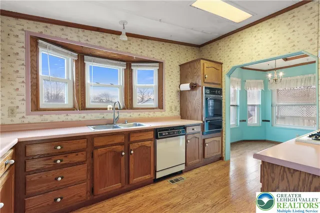 a kitchen with stainless steel appliances granite countertop a sink and a stove