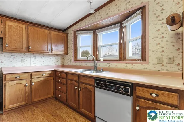 a kitchen with stainless steel appliances granite countertop a stove a sink dishwasher and a refrigerator