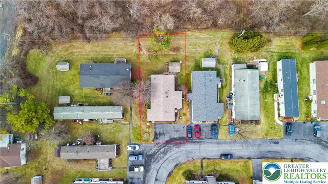 a white house that has tree in front of it