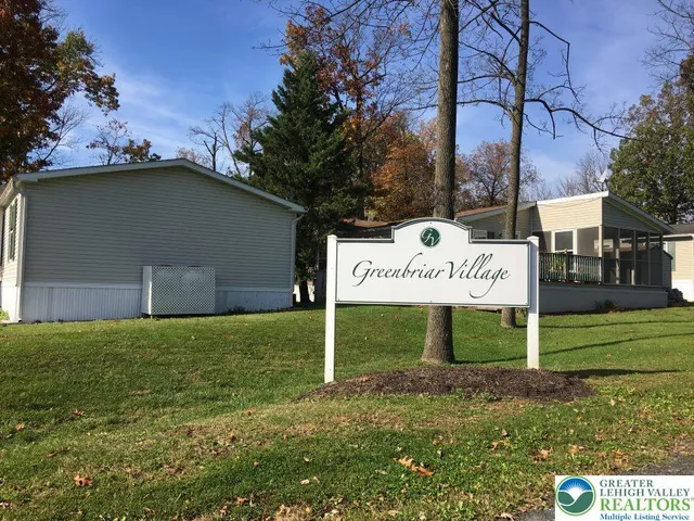 a backyard of a house with yard table and chairs