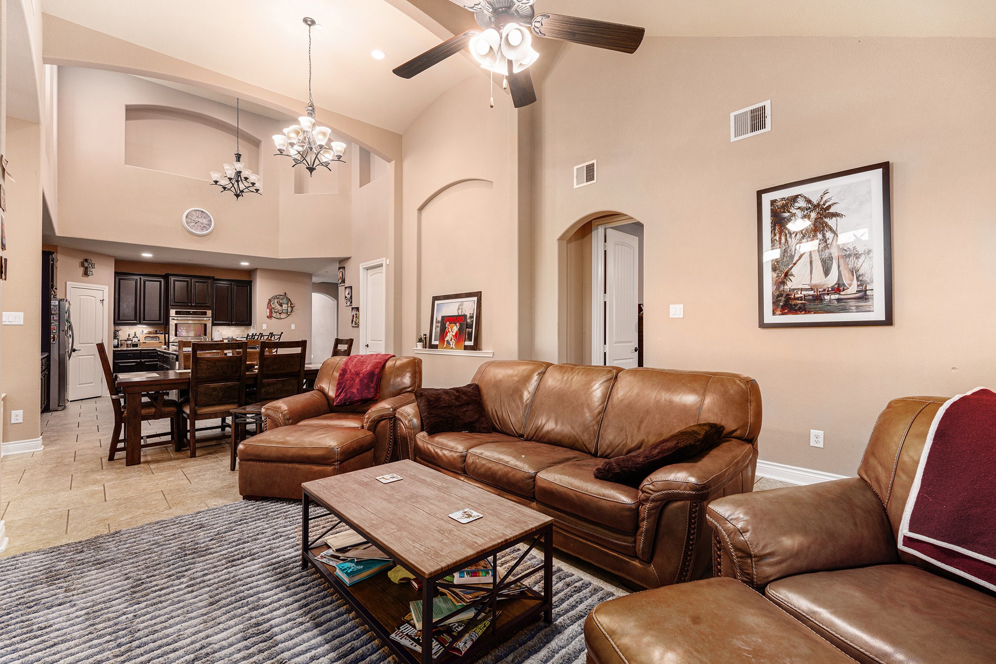 9039 Centennial Drive Conroe, TX 77384 - Photo 4 of 16 a living room with furniture a chandelier and a rug