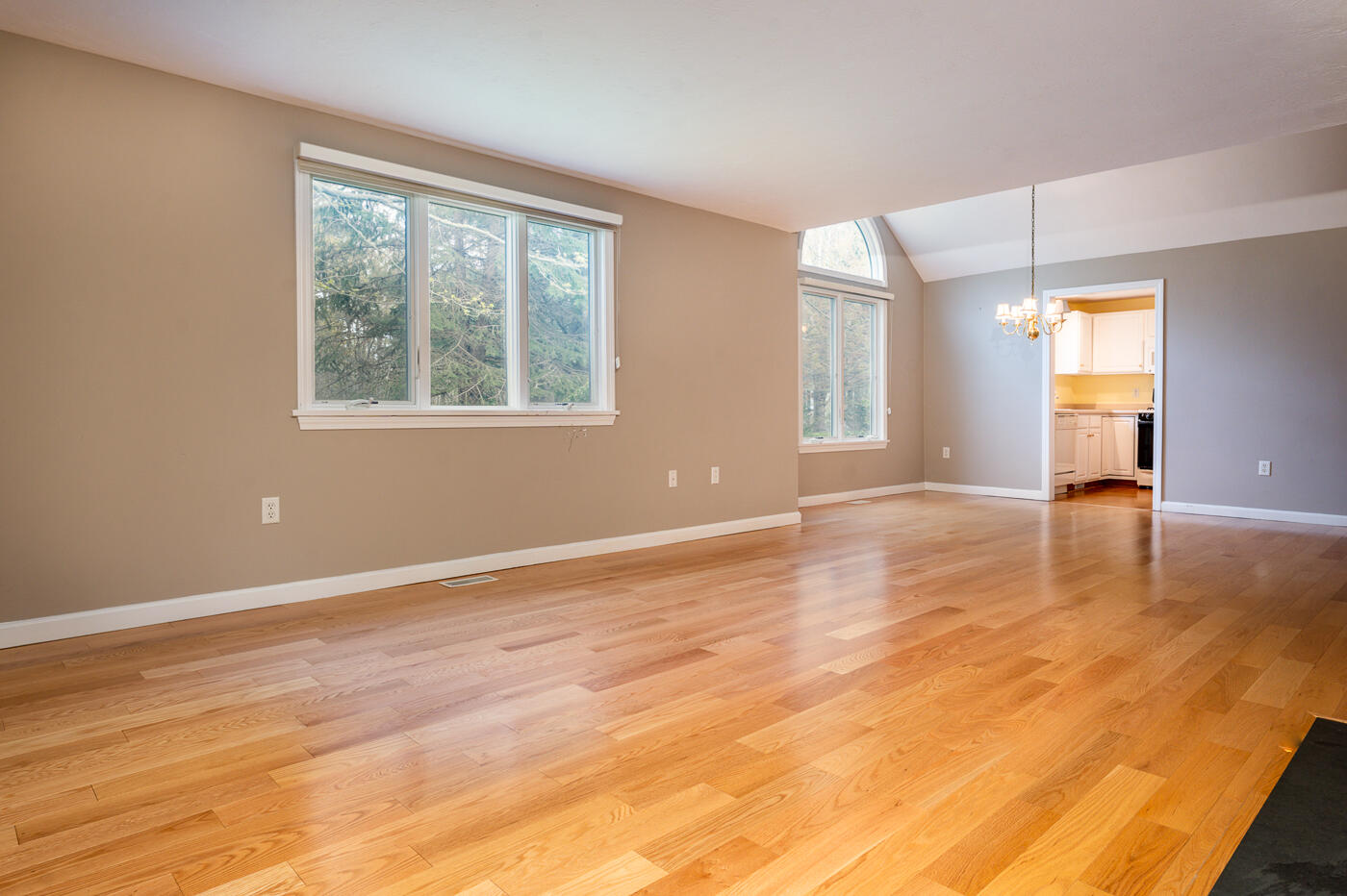 9 Executive Drive Mashpee, MA 02649 - Photo 6 of 15 a view of an empty room with window and wooden floor