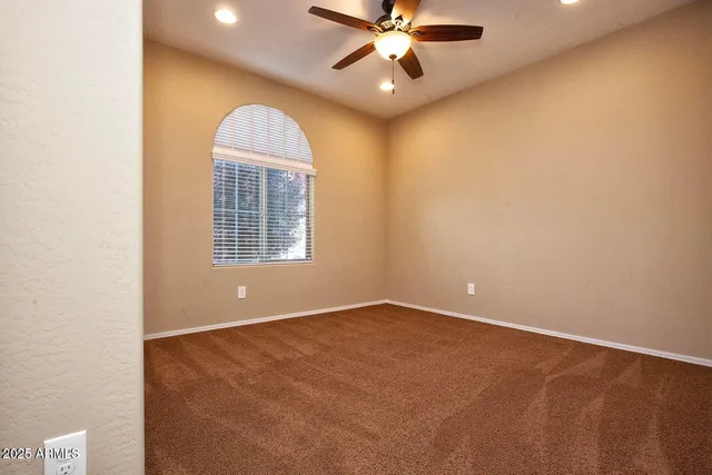 a view of room with a ceiling fan