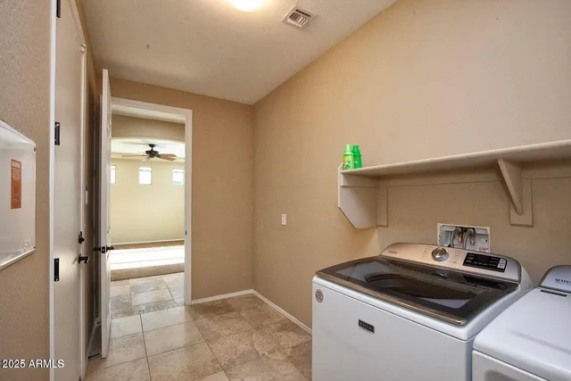 a view of entryway with window and ceiling fan