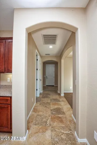 a kitchen with stainless steel appliances granite countertop a refrigerator a sink and a stove