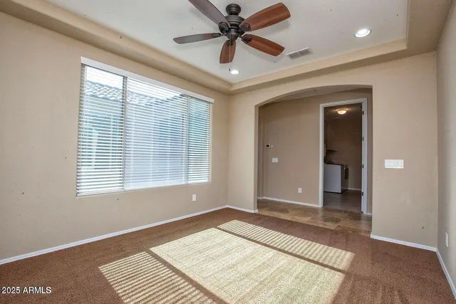 a view of a hallway with stainless steel appliances a refrigerator and a window