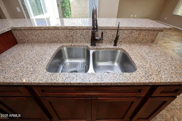 a kitchen with stainless steel appliances granite countertop a refrigerator and a sink