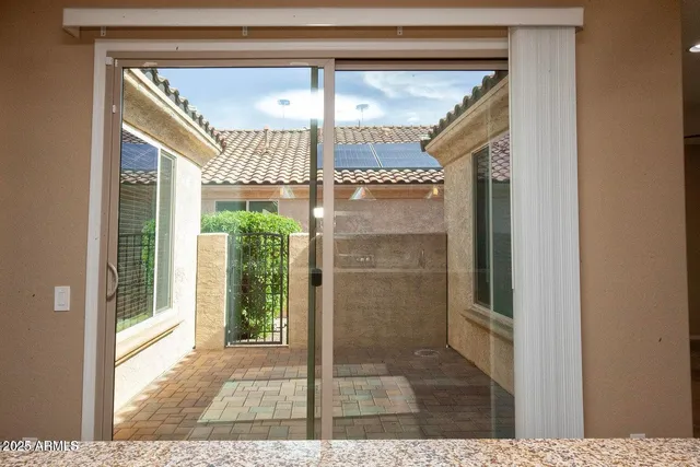 a view of a backyard with plants and a lake view