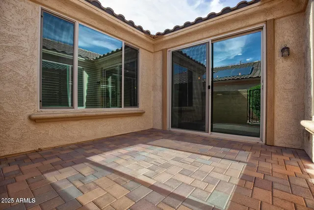 a backyard of a house with outdoor seating