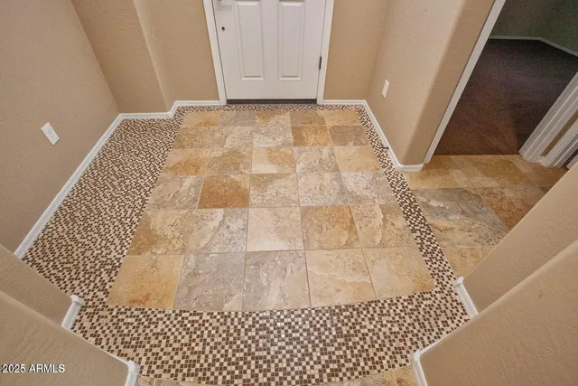 an empty room with a ceiling fan and a window